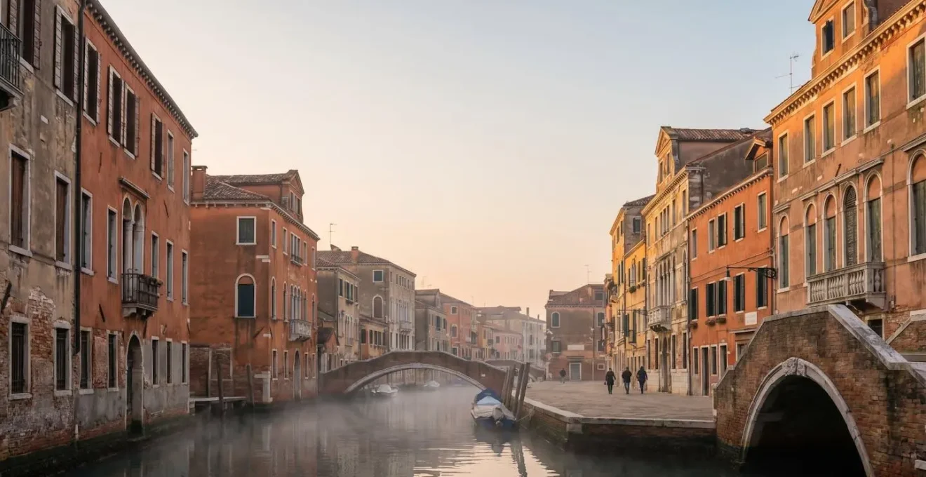 Venetian canal with traditional colorful facades and authentic residential district at golden hour